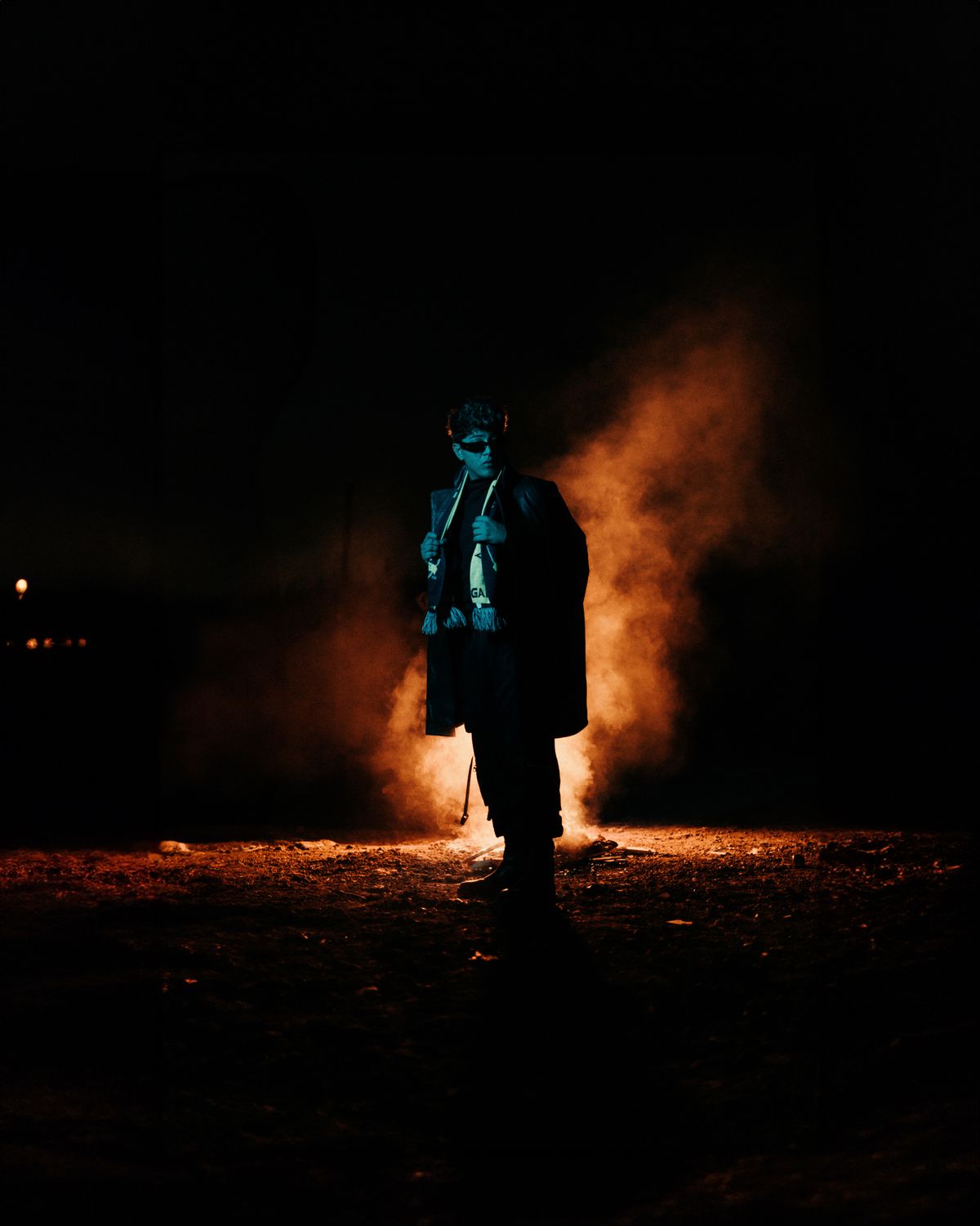 A man in a suit standing in front of a fire · Free Stock Photo