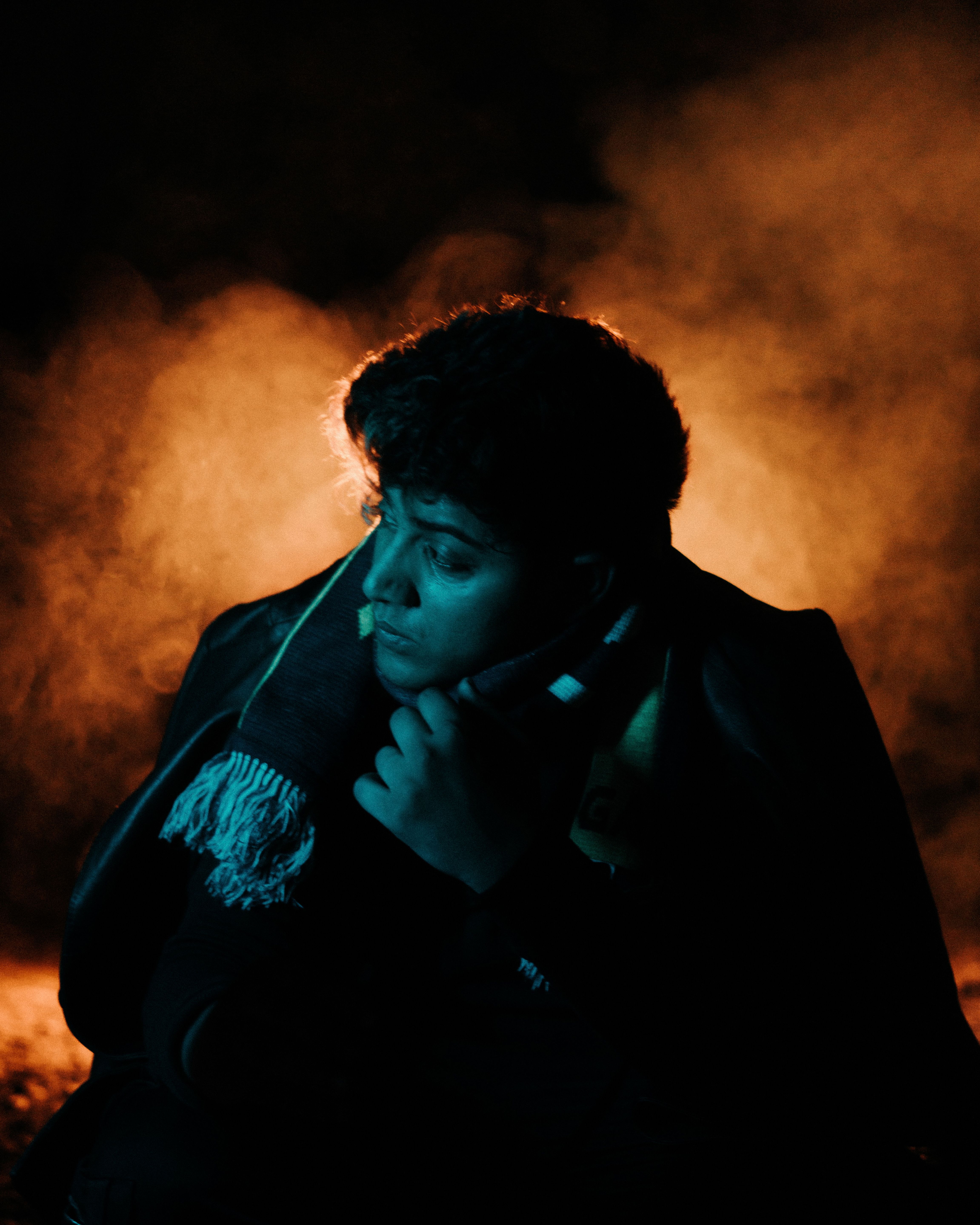 A man sitting in the dark with smoke coming out of his mouth · Free ...