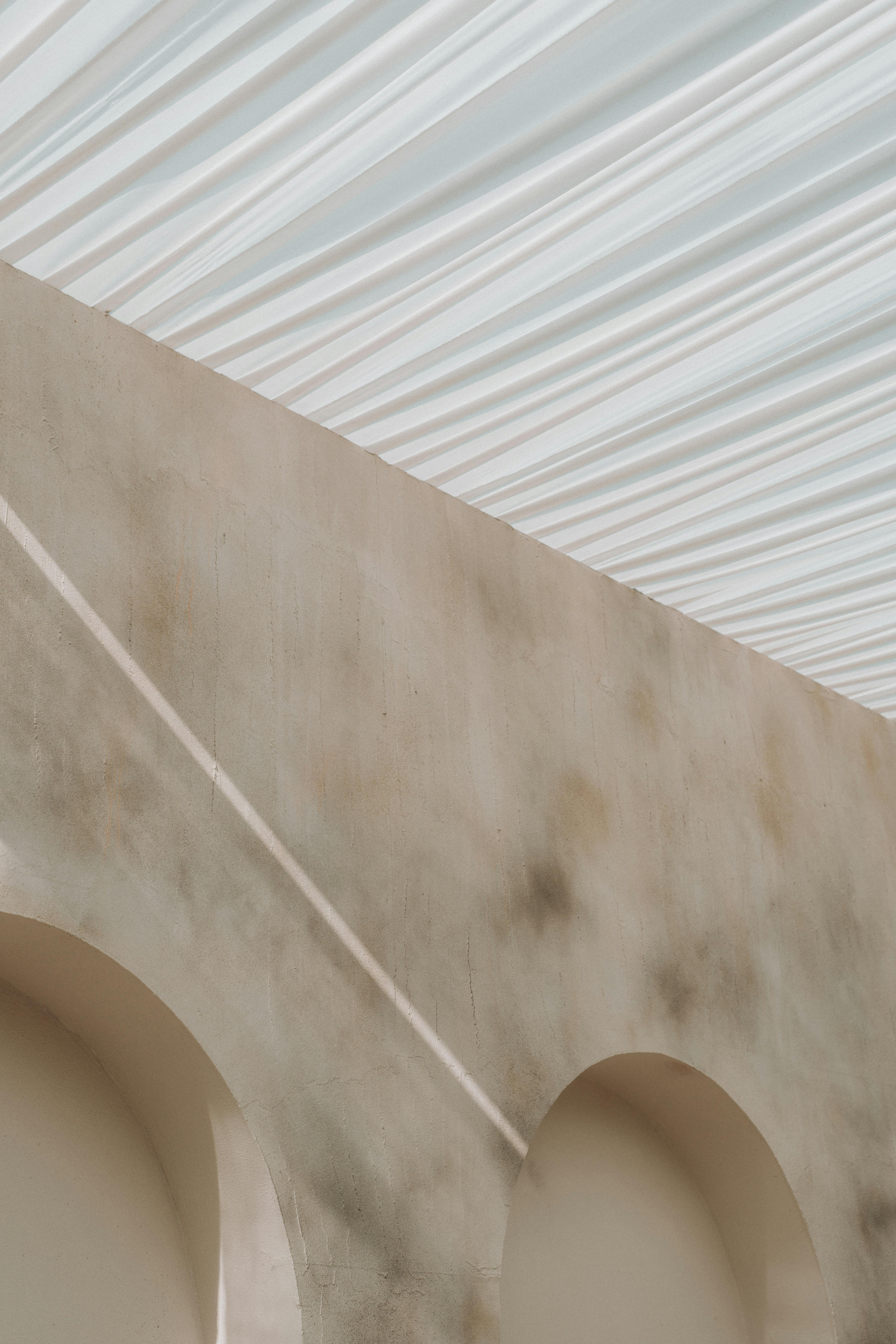 A captivating image of a minimalist architectural design featuring soft light on curved arches.