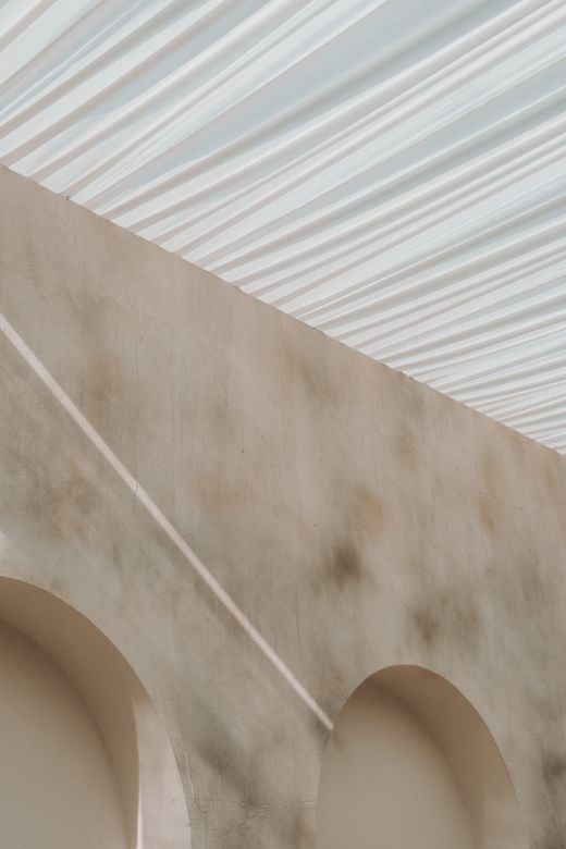 Stone arches under a fluted ceiling — photo by Manish Jangid on Pexels