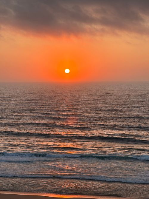 Free Stunning sunset view over the ocean at A dos Cunhados, Portugal, capturing vibrant colors. Stock Photo