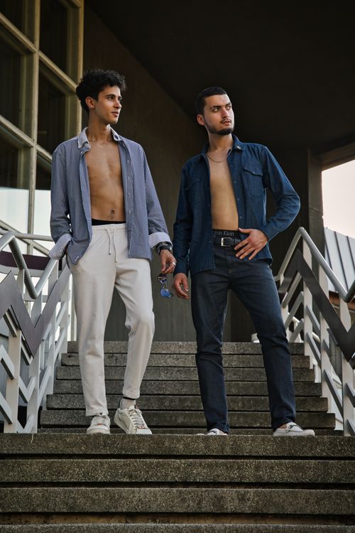 Free Two male models pose stylishly on outdoor stairs in Berlin, Germany, showcasing urban fashion trends. Stock Photo