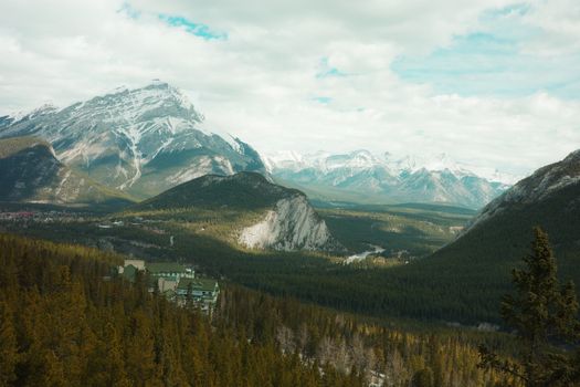 Explore the serene beauty of Alberta's Canadian Rockies with snow-capped peaks and lush forests.