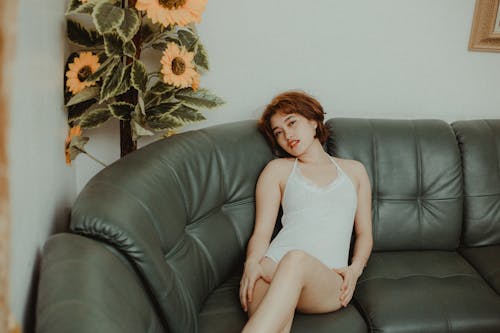 Photo Of Woman Sitting On Sofa