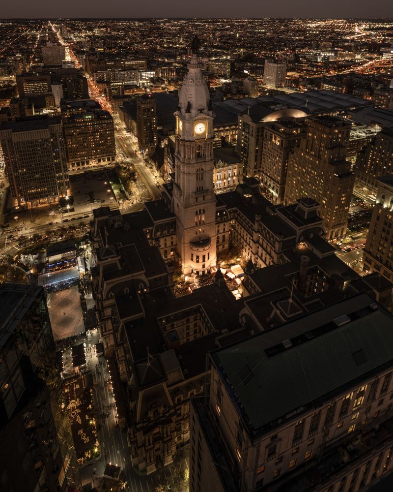 Aerial night view of Philadelphia City Hall with its illuminated clock tower