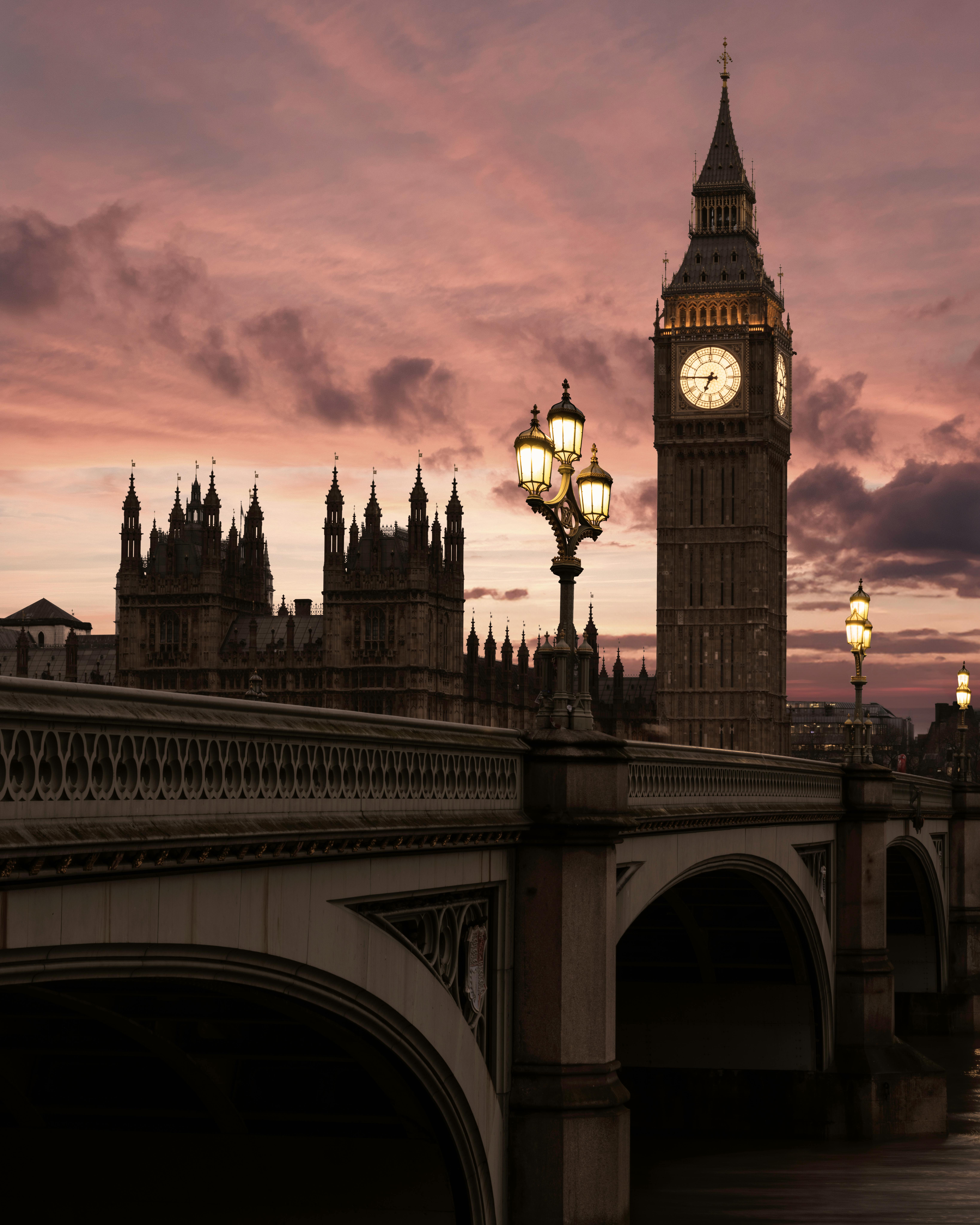 Stunning view of Big Ben and the Houses of Parliament at sunset, captured from Westminster Bridge in London, UK.