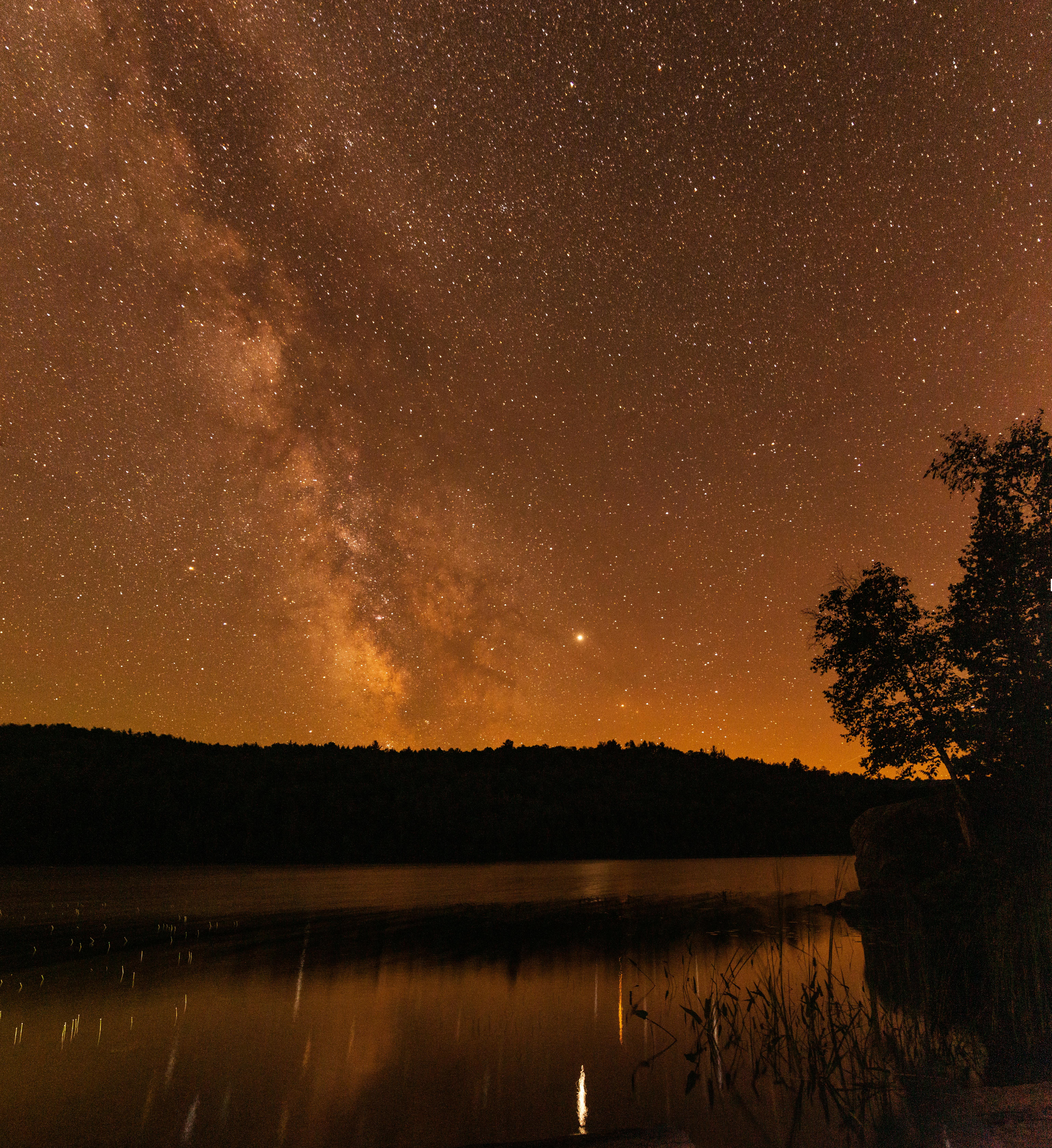 宁静的夜晚，湖面上映照出令人惊叹的银河，广阔的星空尽收眼底