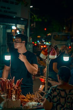 Vibrant night market in Hanoi featuring food stalls and bustling atmosphere.