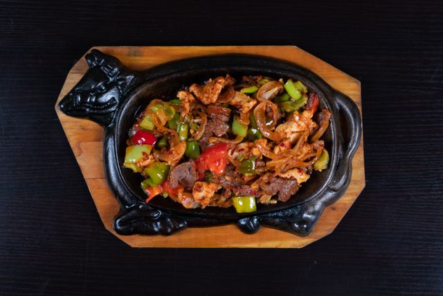 Flavorful beef and vegetable stir-fry served hot on a unique cast iron skillet, perfect for dinner.