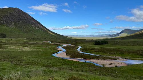Free Explore the serene beauty of a flowing river through the Scottish Highlands. Stock Photo