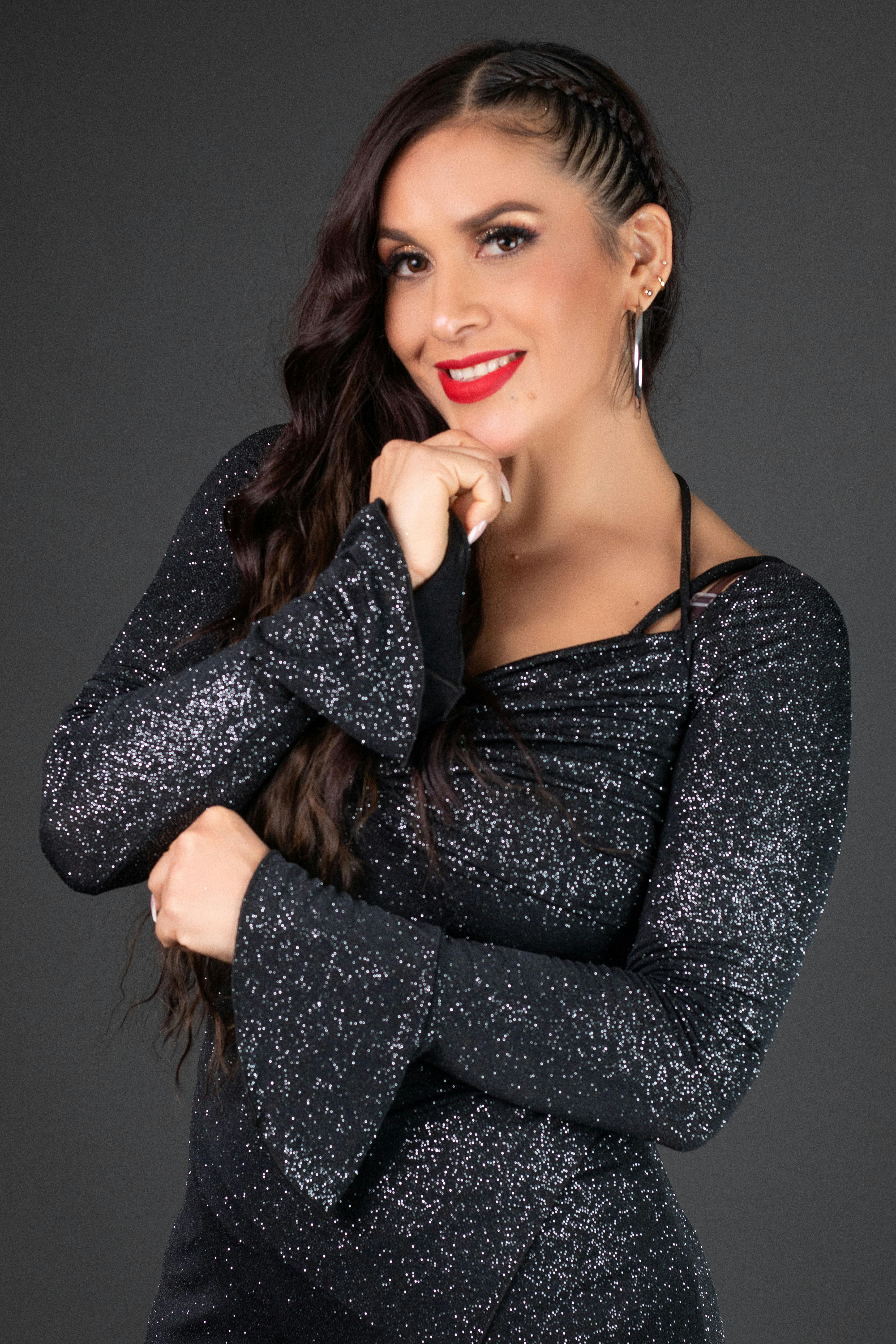 Portrait of a stylish woman in a glittering dress, showcasing elegance and glamour.
