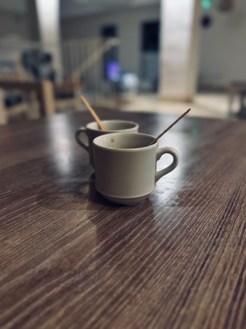 Two coffee cups on a rustic wooden table — Pedro Dias on Pexels