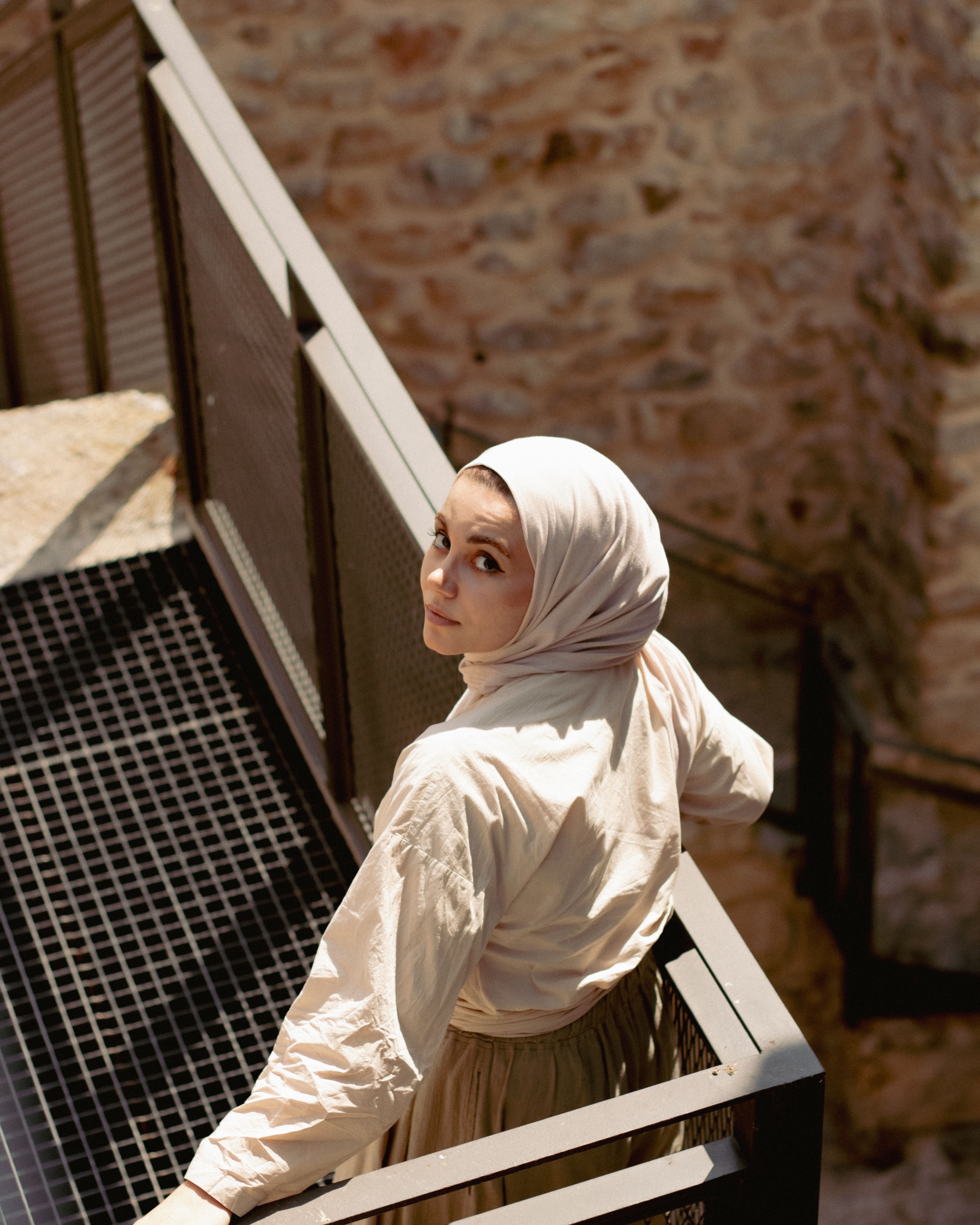 A woman in a hijab standing on a stairway · Free Stock Photo