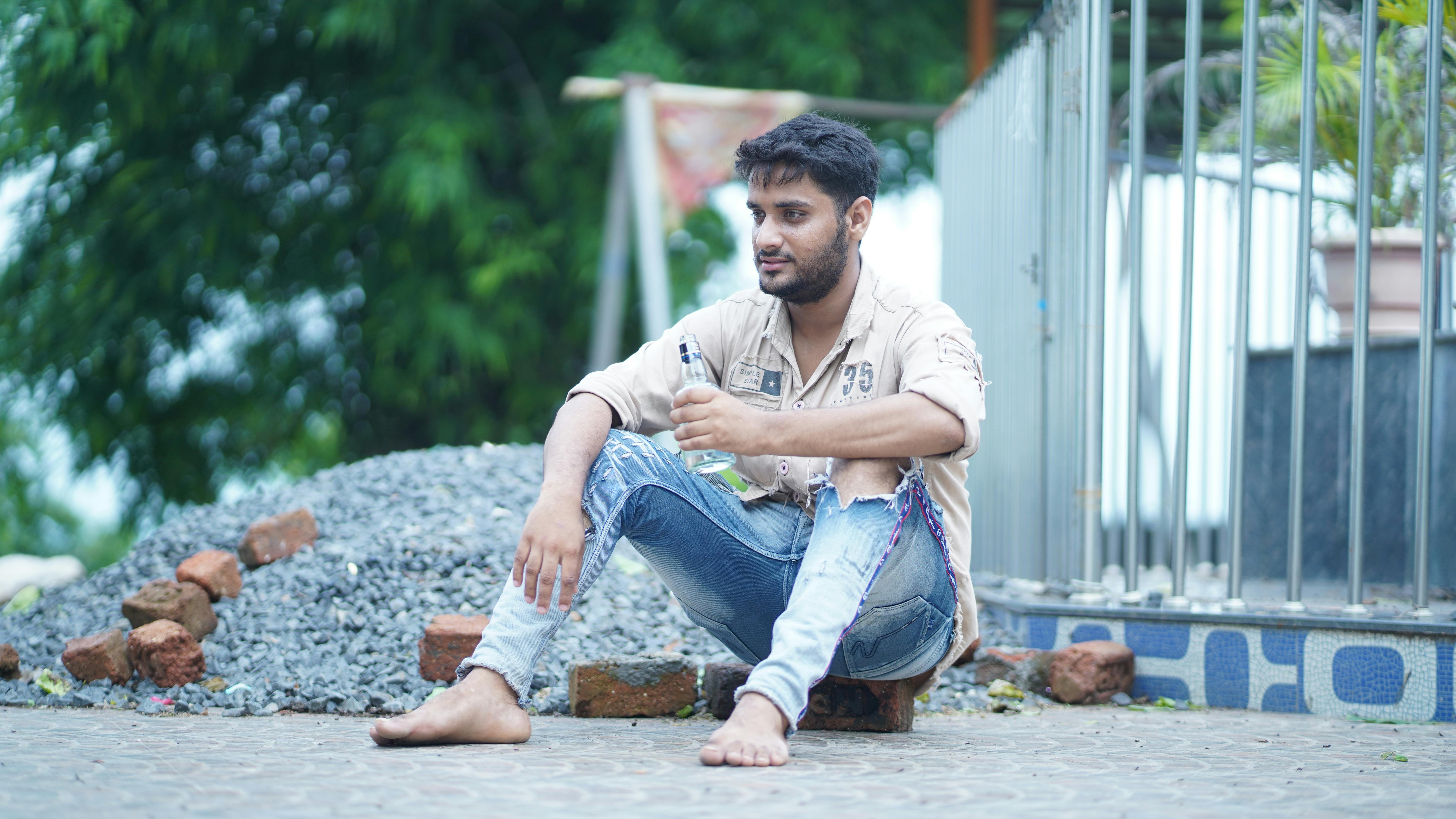 a man sitting on the ground with his feet up