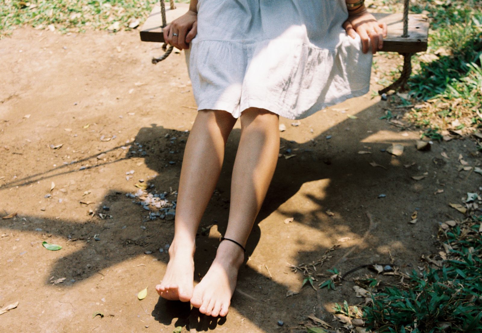 Runner tying a supportive ankle brace before an outdoor walk