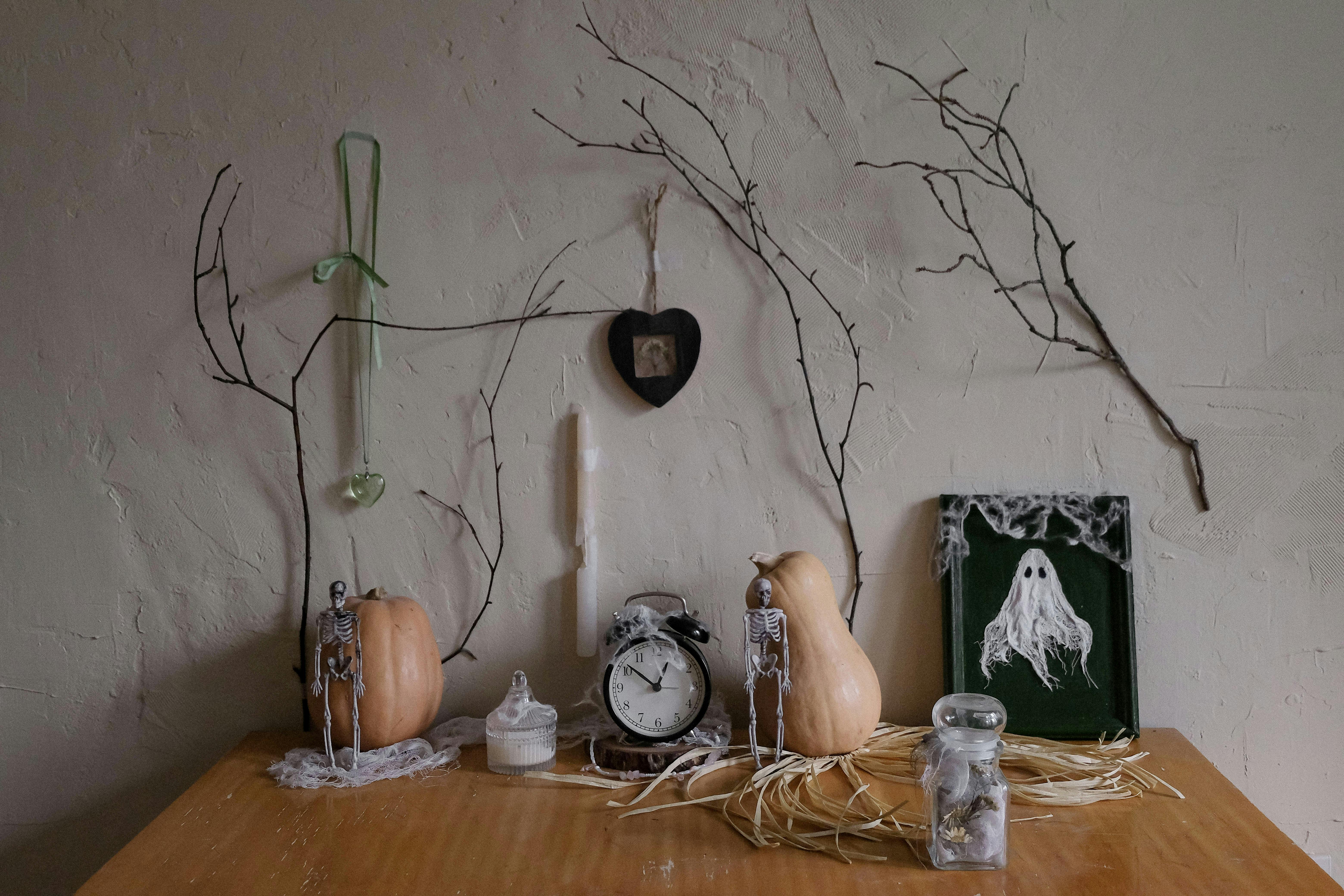 A spooky Halloween-themed table setting with vintage decor and pumpkins.
