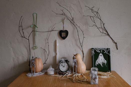 A spooky Halloween-themed table setting with vintage decor and pumpkins.