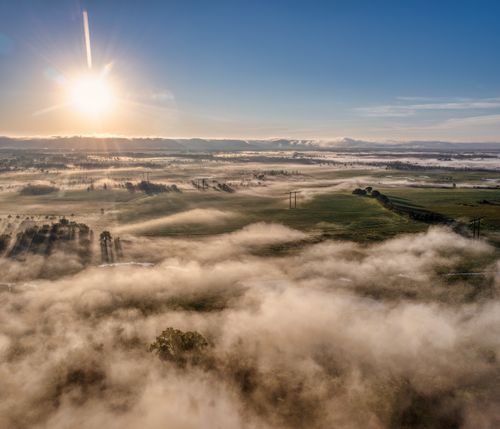 Free Breathtaking aerial view of sunrise over misty fields in Kellogg, MN showcasing a serene landscape. Stock Photo