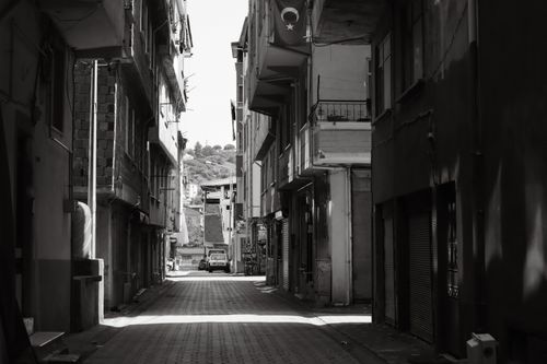 Free Explore a shadowy, narrow alleyway in Ünye, Turkey, with classic architecture and urban charm. Stock Photo