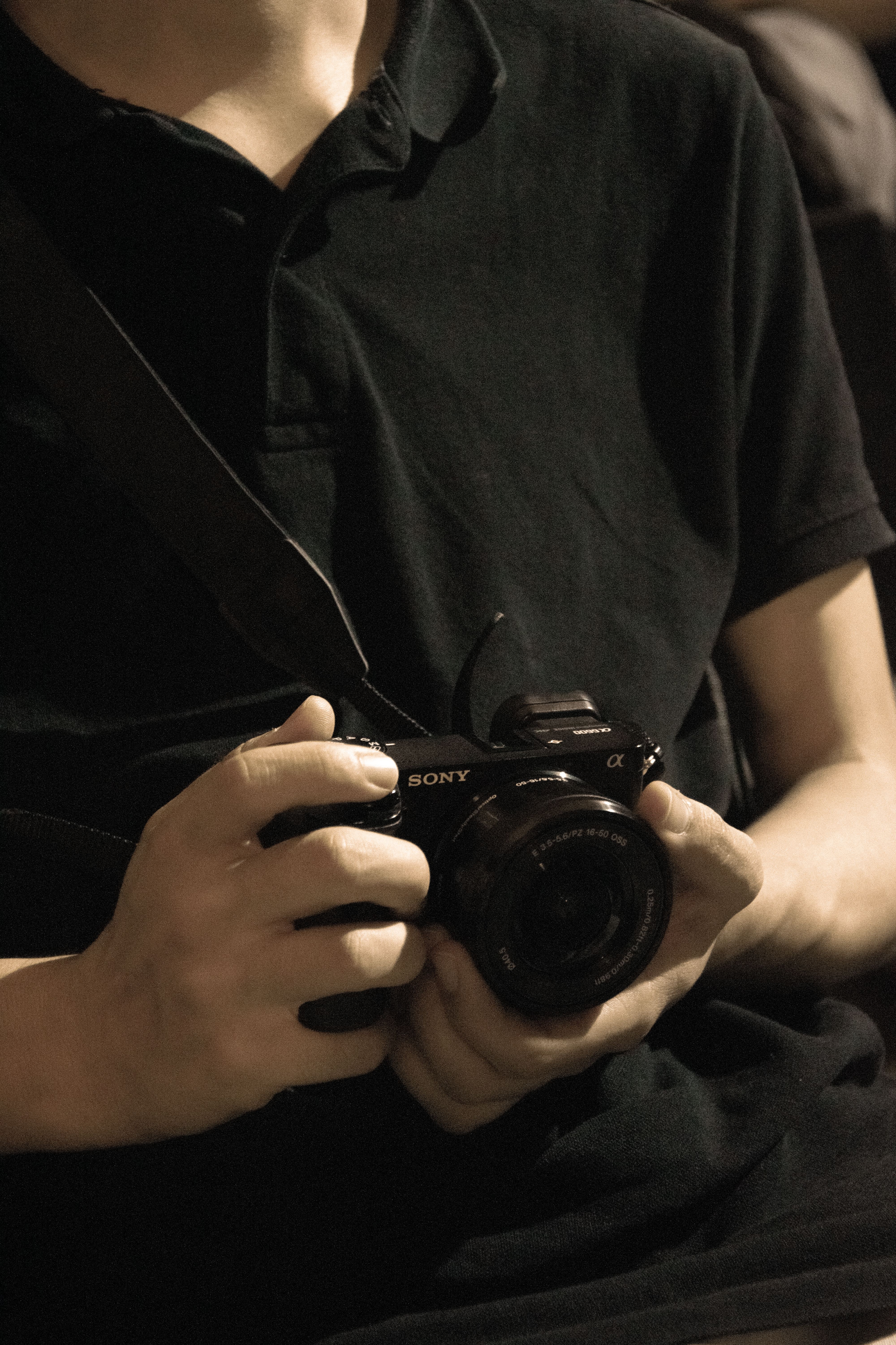 Young adult with a camera in hand, embodying a modern and artistic vibe.