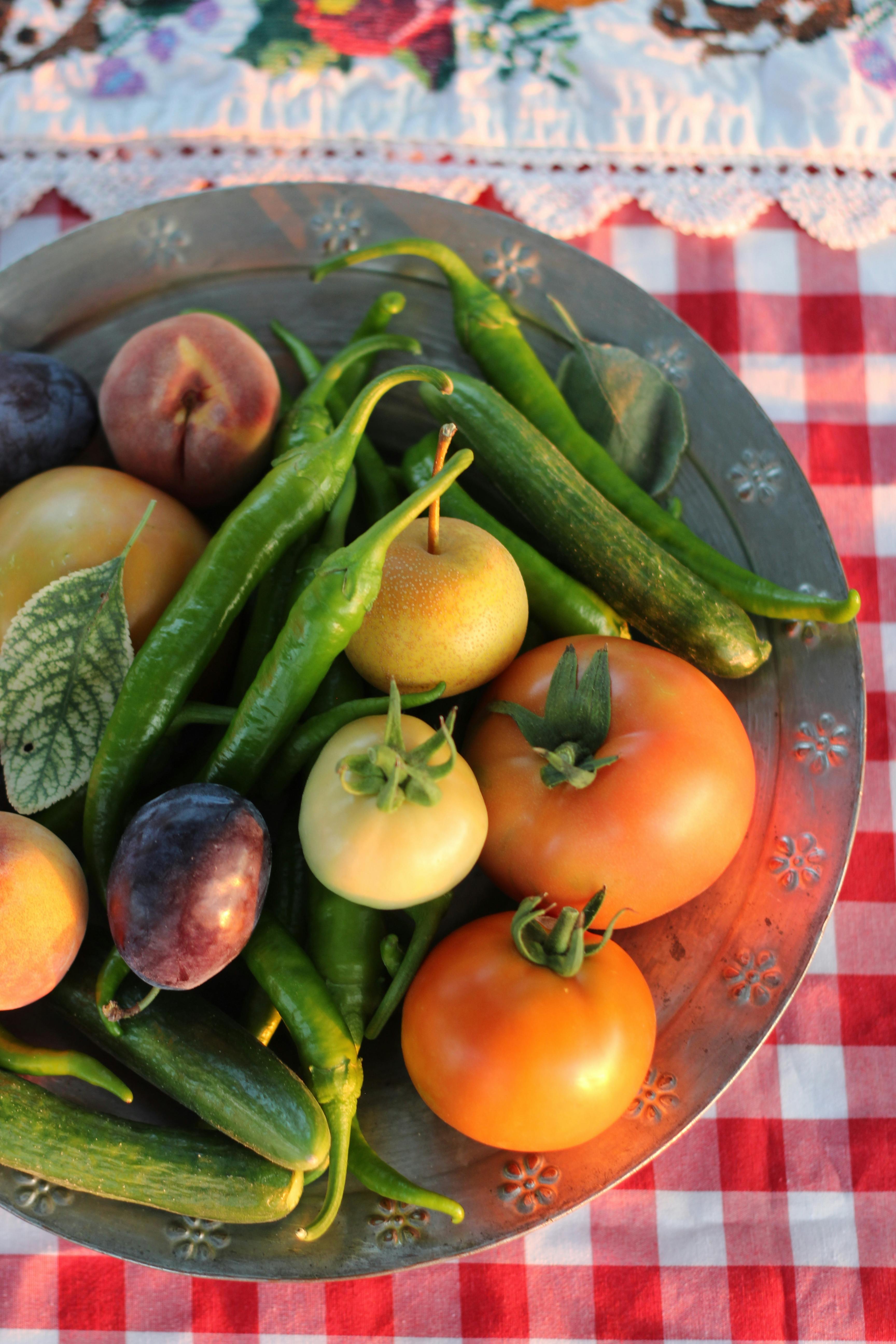 A plate of fresh fruits and vegetables on a table