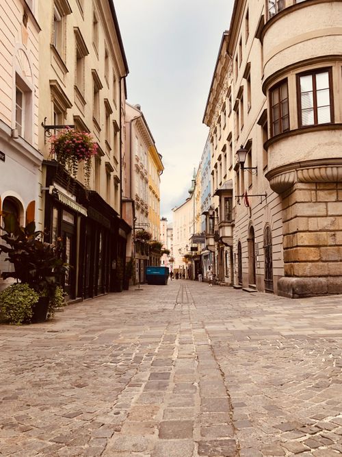Free Charming cobblestone street with historic buildings in Linz's old town, Austria, showcasing European architecture. Stock Photo