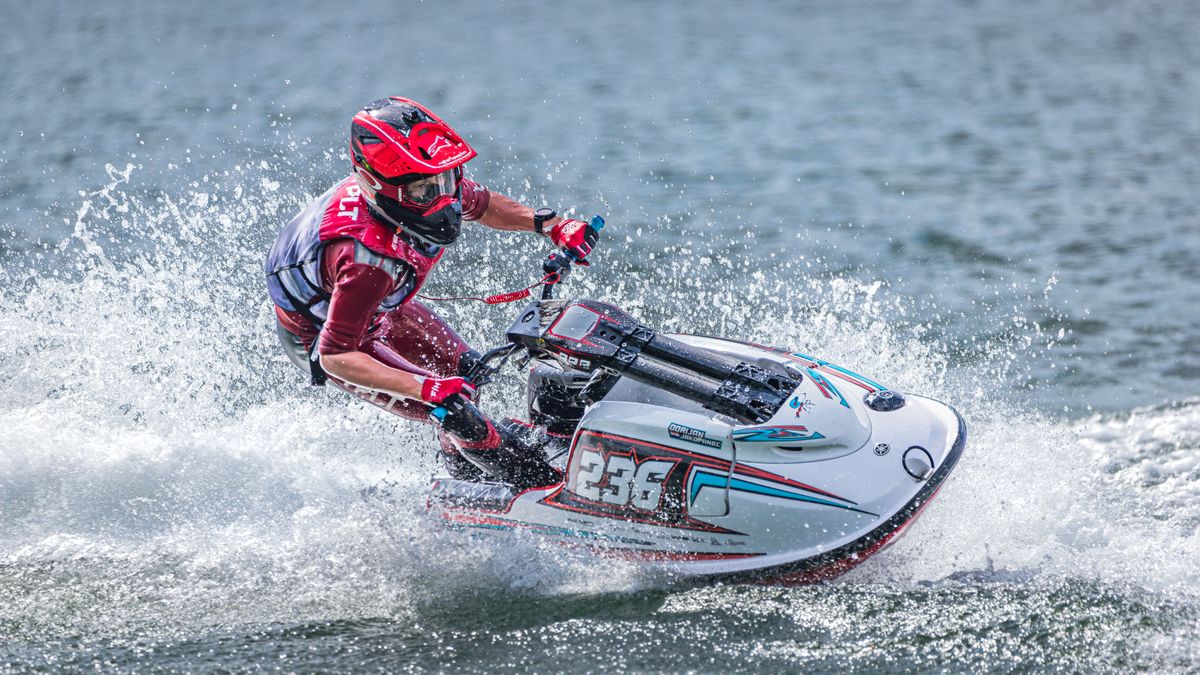 Jet ski rider racing across blue water