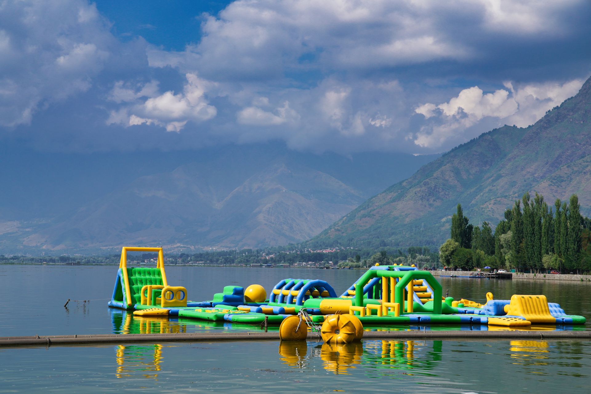 A water park with a large inflatable obstacle course
