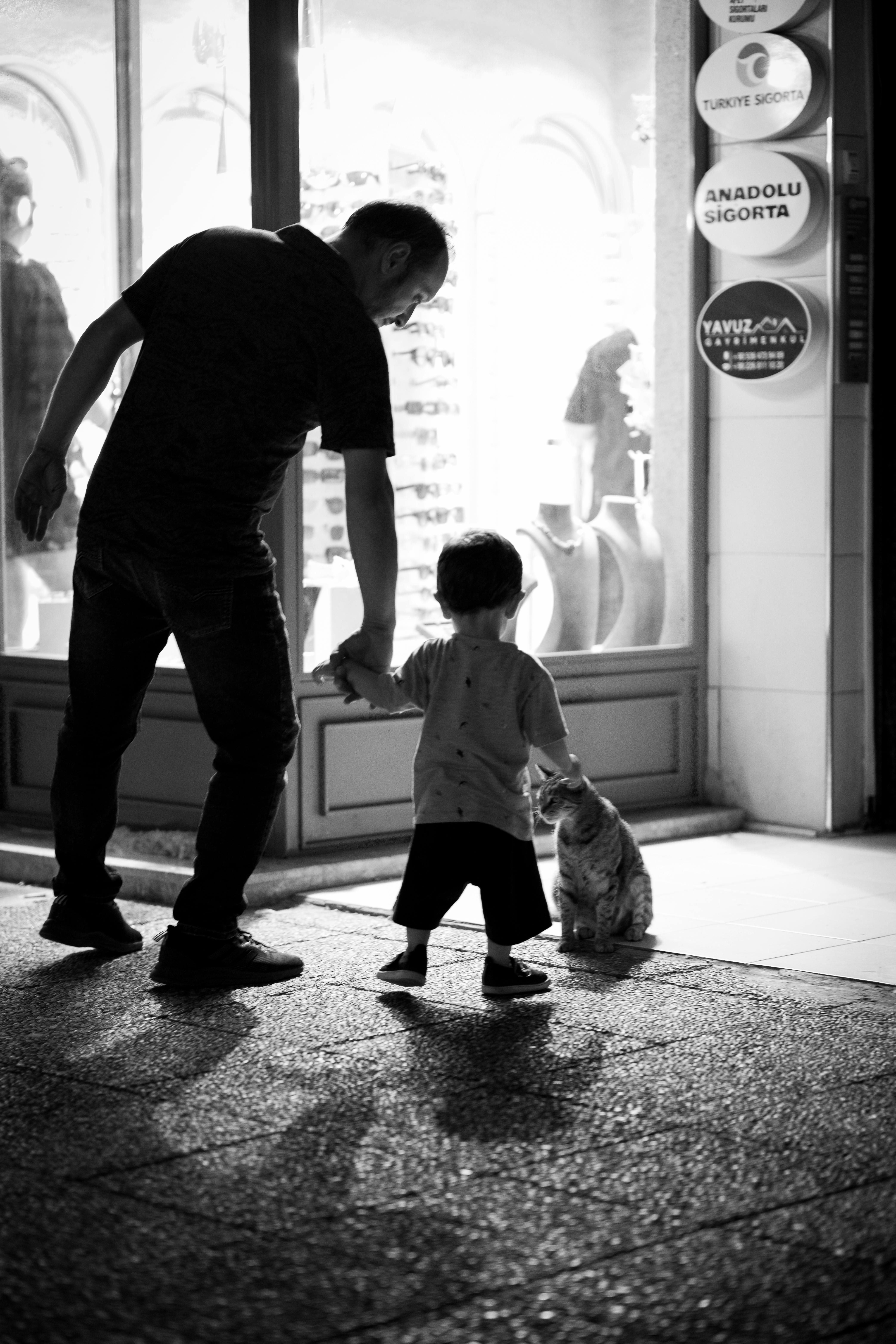 a man and child walking down the street