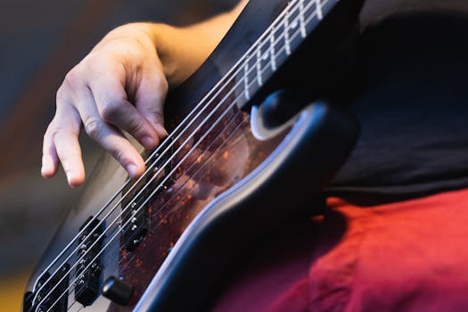 Detailed shot of a bass guitarist in action at a live performance.