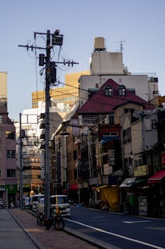 Urban street view in Tokyo, Japan featuring traditional architecture and transportation.