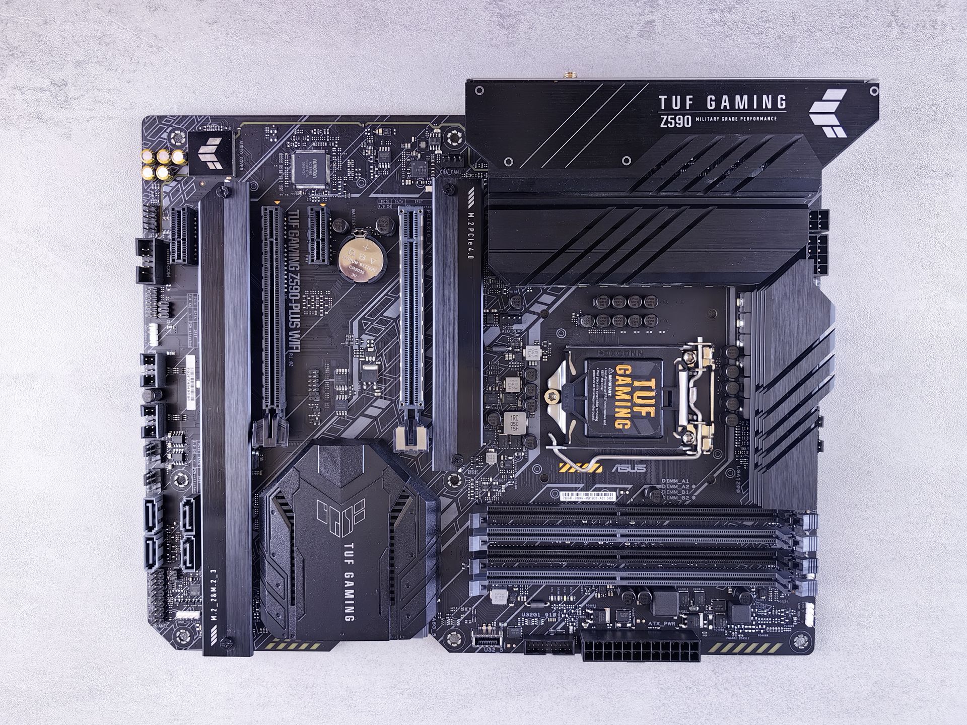 High-quality image of ASUS TUF Gaming Z590 motherboard showcasing intricate electronic details.
