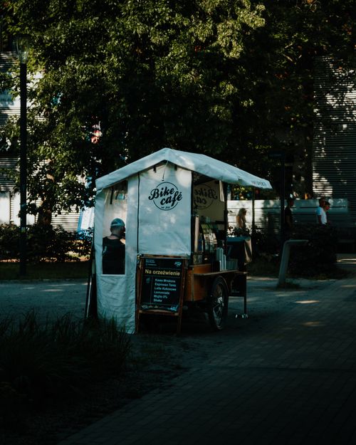 Free Charming bike café booth on a city street serving coffee and snacks outdoors. Stock Photo