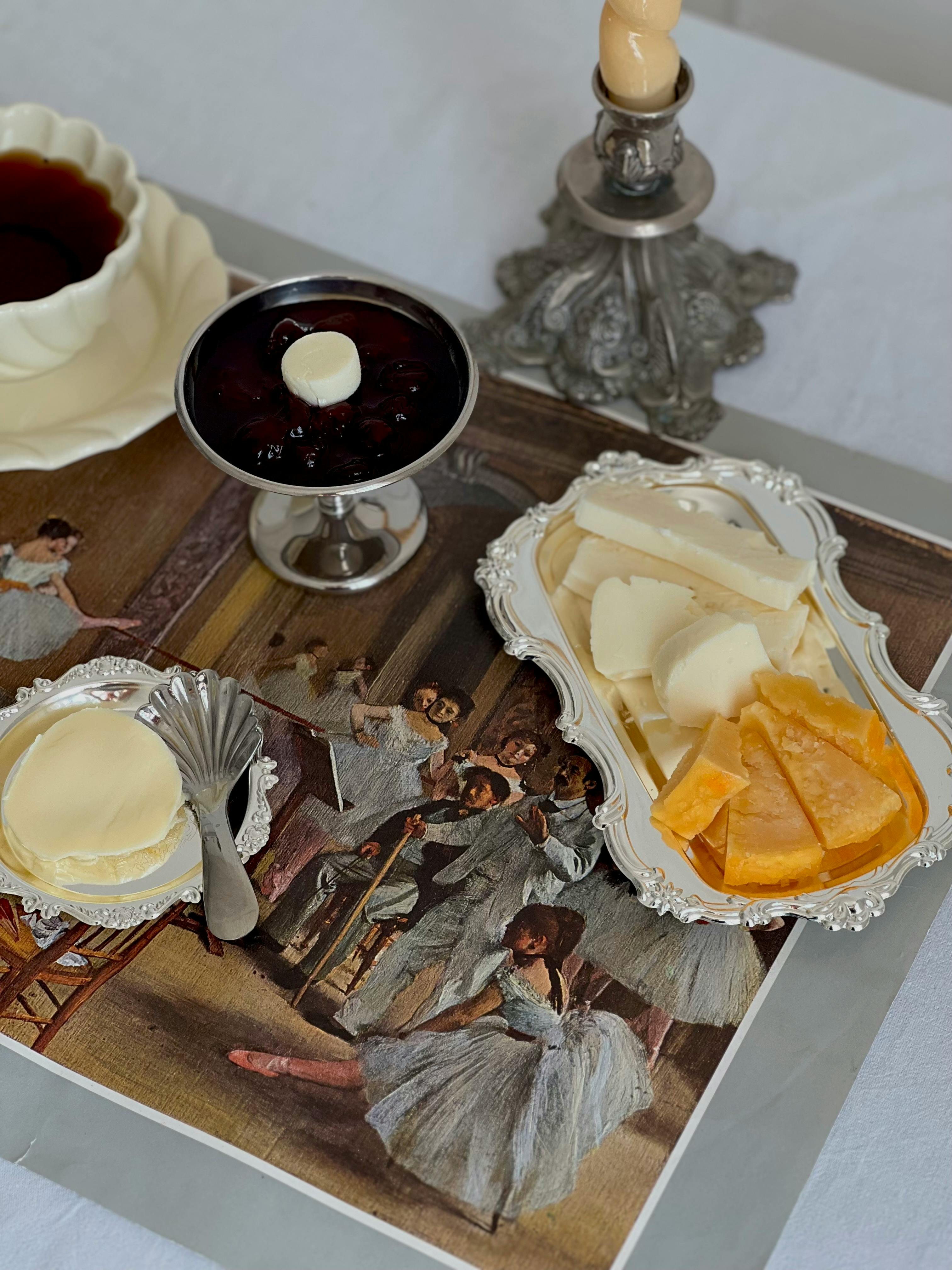 a tray with cheese jam and other items on it