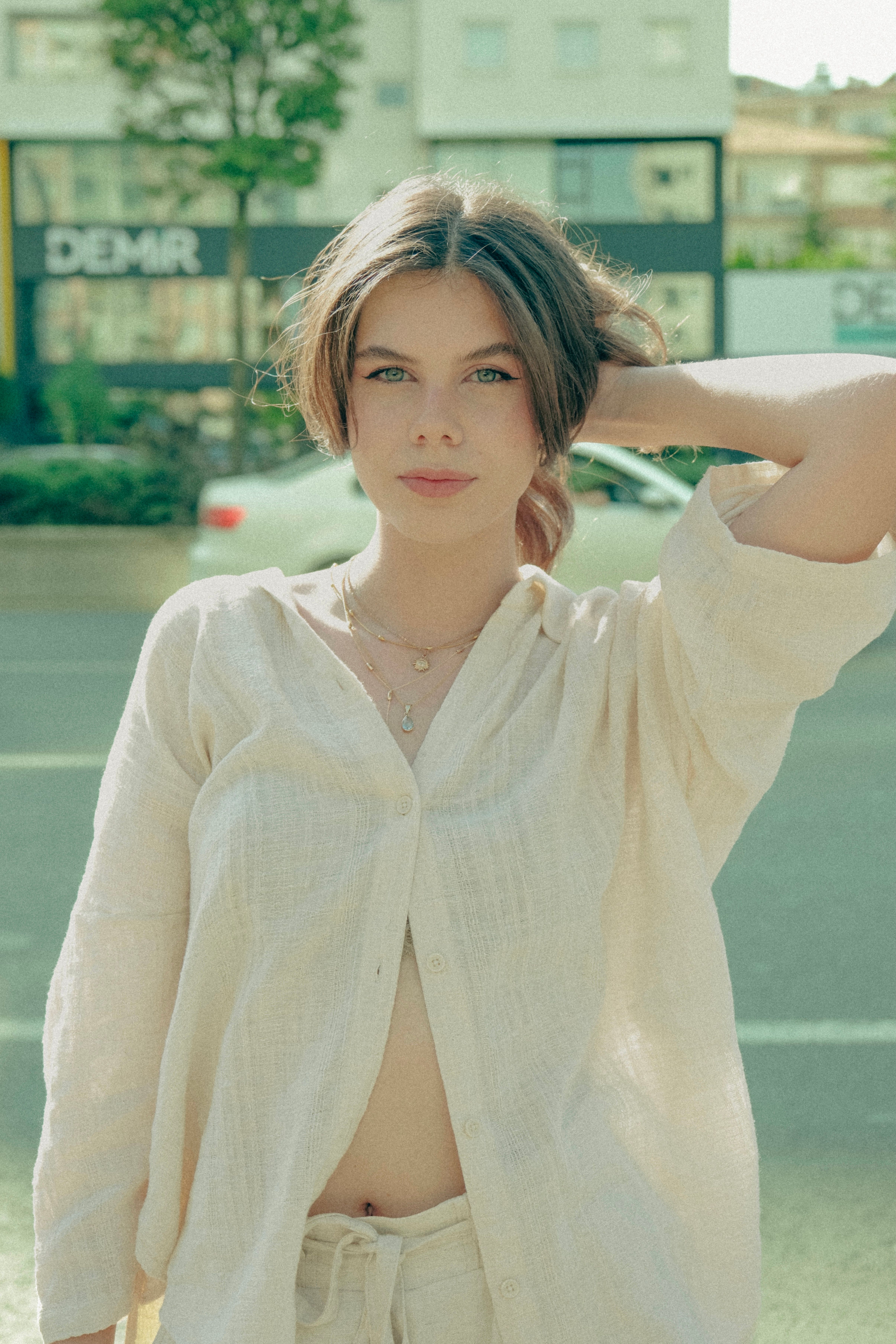 A woman in a white shirt and pants standing on the street · Free Stock ...