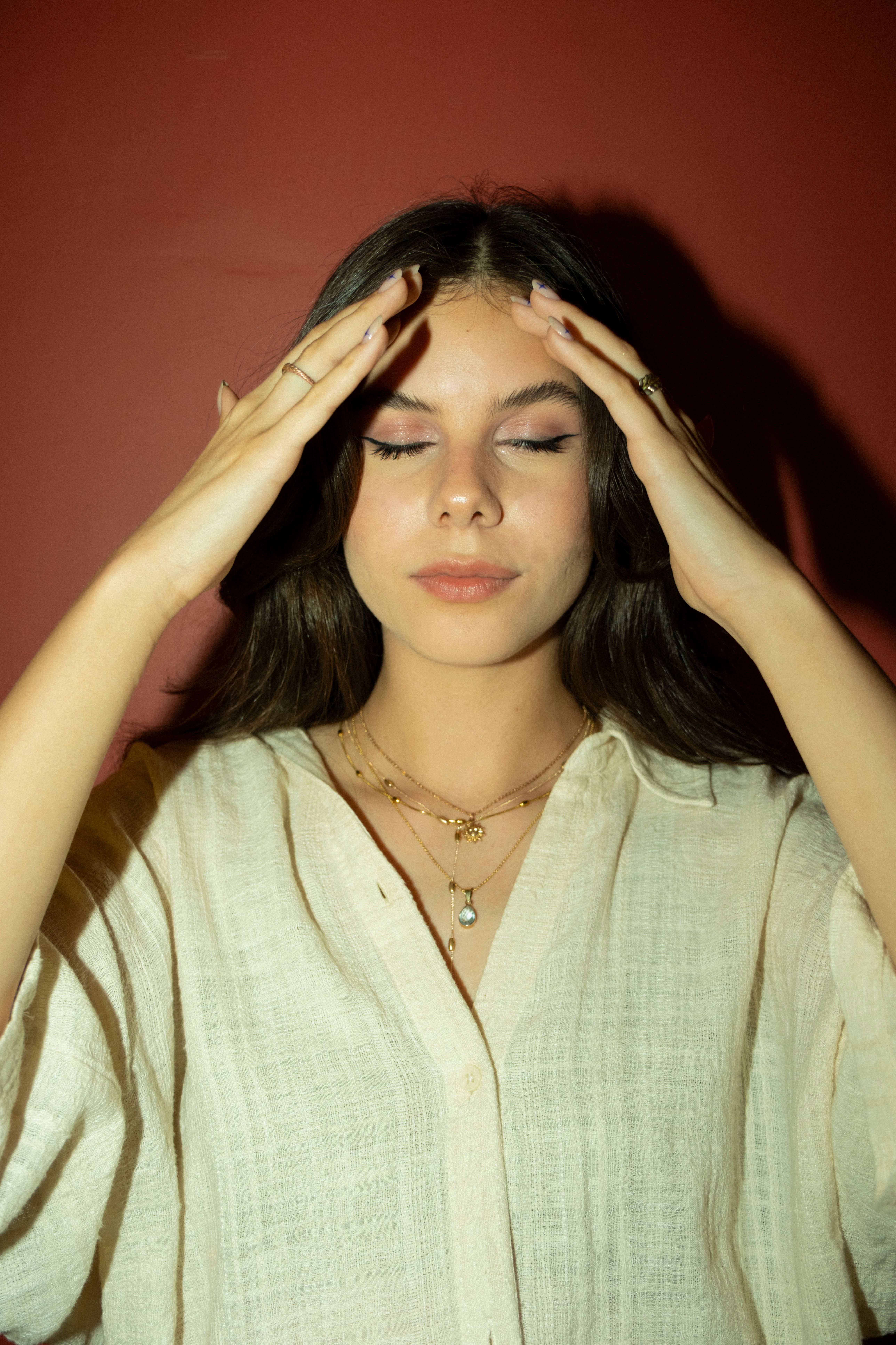 A woman with her hands on her head · Free Stock Photo