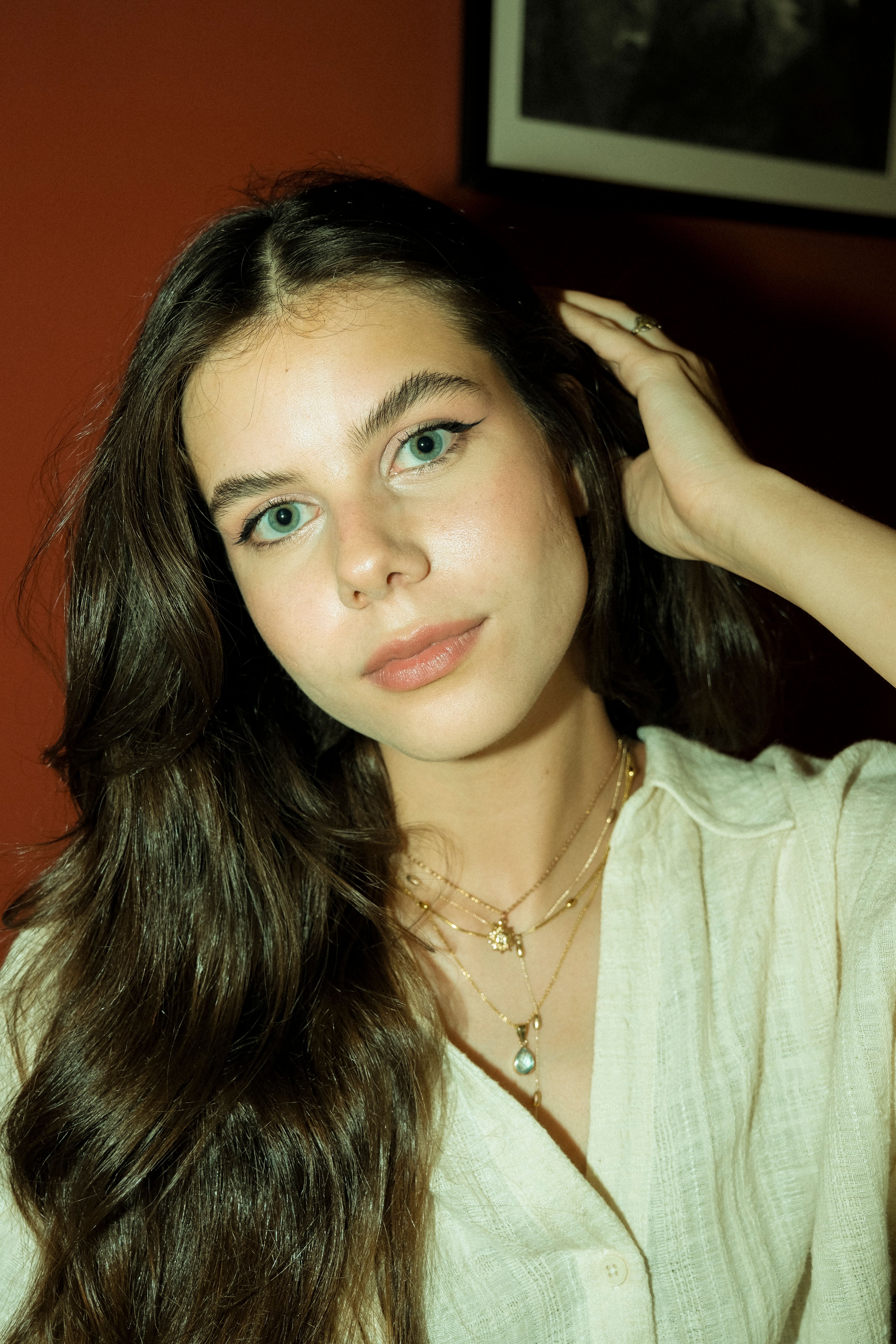 A captivating portrait of a young woman with long hair, showcasing expressive eyes and a serene expression.
