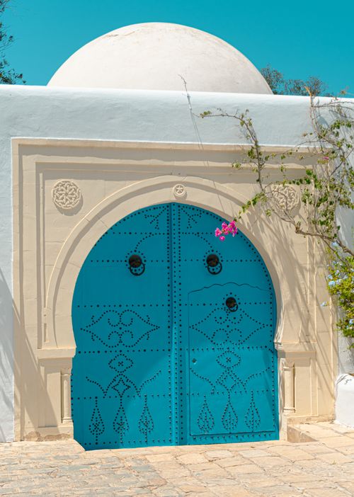 Free A striking blue traditional arch doorway in Carthage, Tunisia under a clear sky. Stock Photo