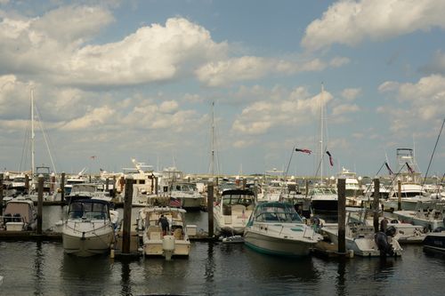 Free Serene marina view featuring boats and yachts under a vibrant sky, ideal for travel and boating themes. Stock Photo