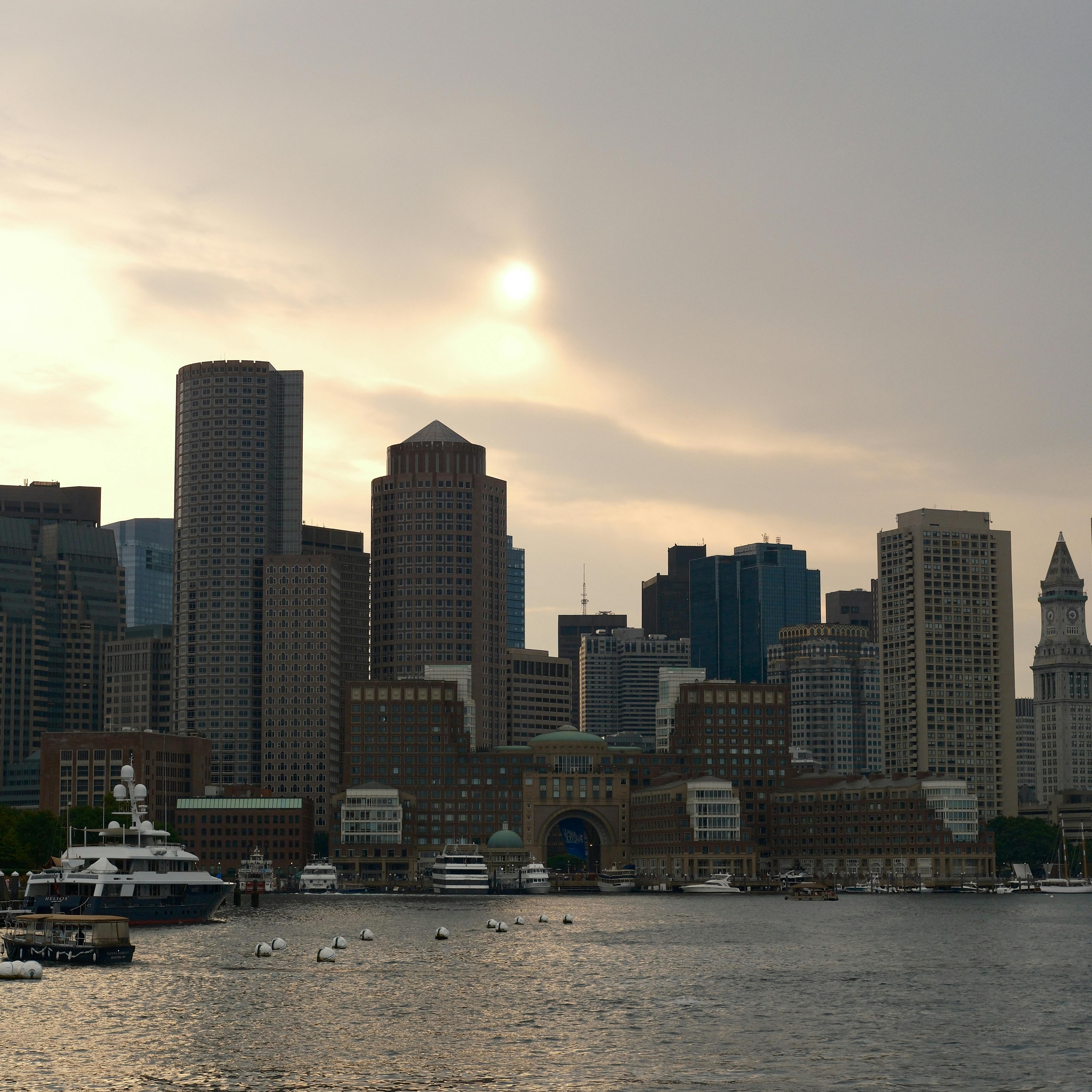 Scenic view of Boston's skyline and harbor at dusk with a calming atmosphere.