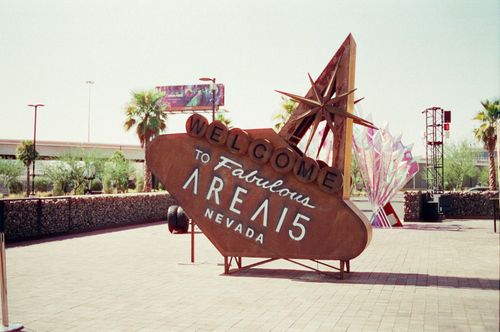 Free Retro-inspired sign 'Welcome to Fabulous AREA15 Nevada' outdoors with palm trees. Stock Photo
