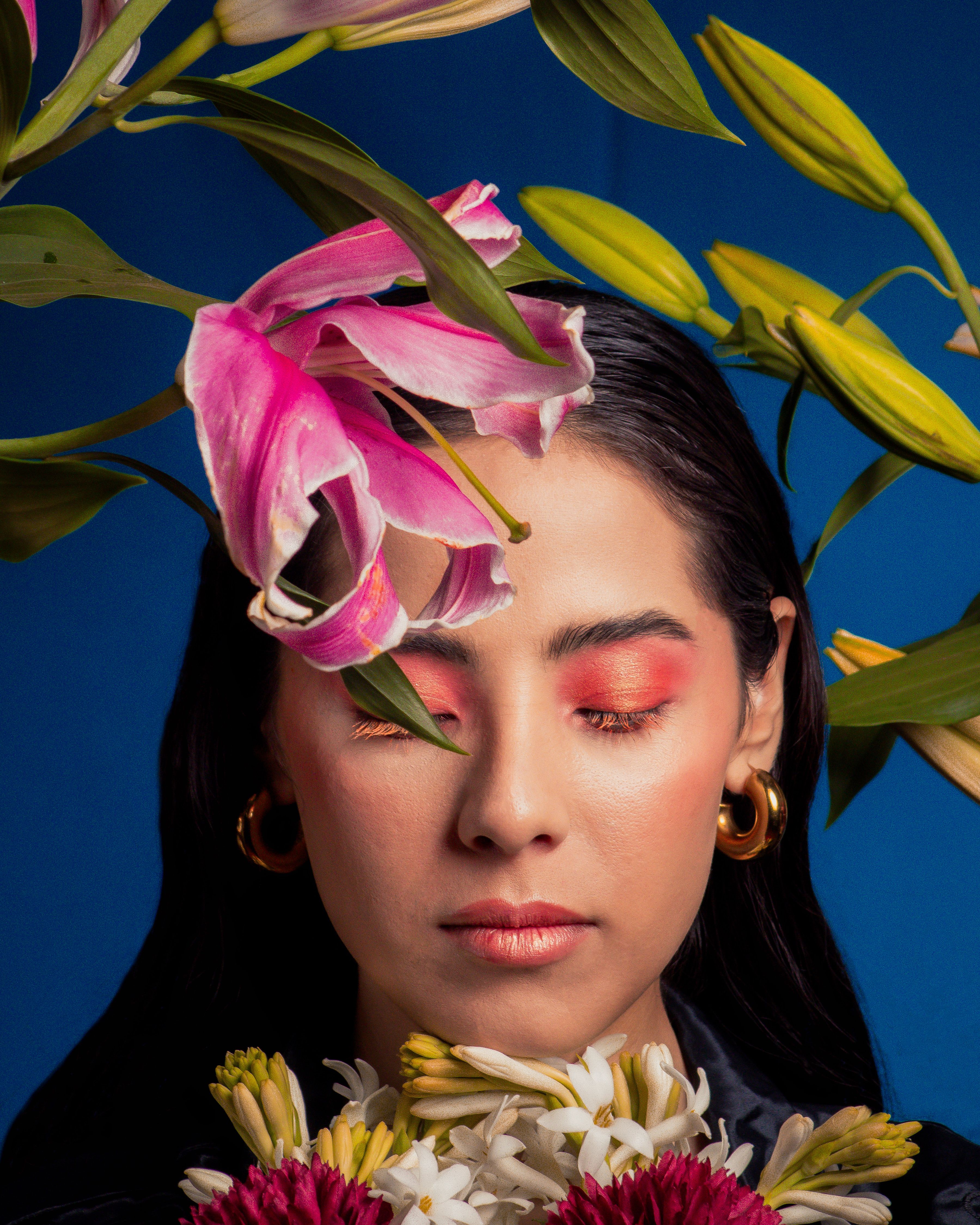 A woman with flowers in her hair and eyes closed · Free Stock Photo