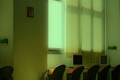 Bright and minimalist office space with computer desks and large windows.