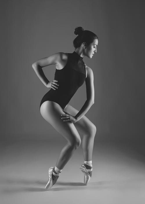 Free Graceful ballerina posing in a dramatic black and white studio shot, highlighting elegance and poise. Stock Photo