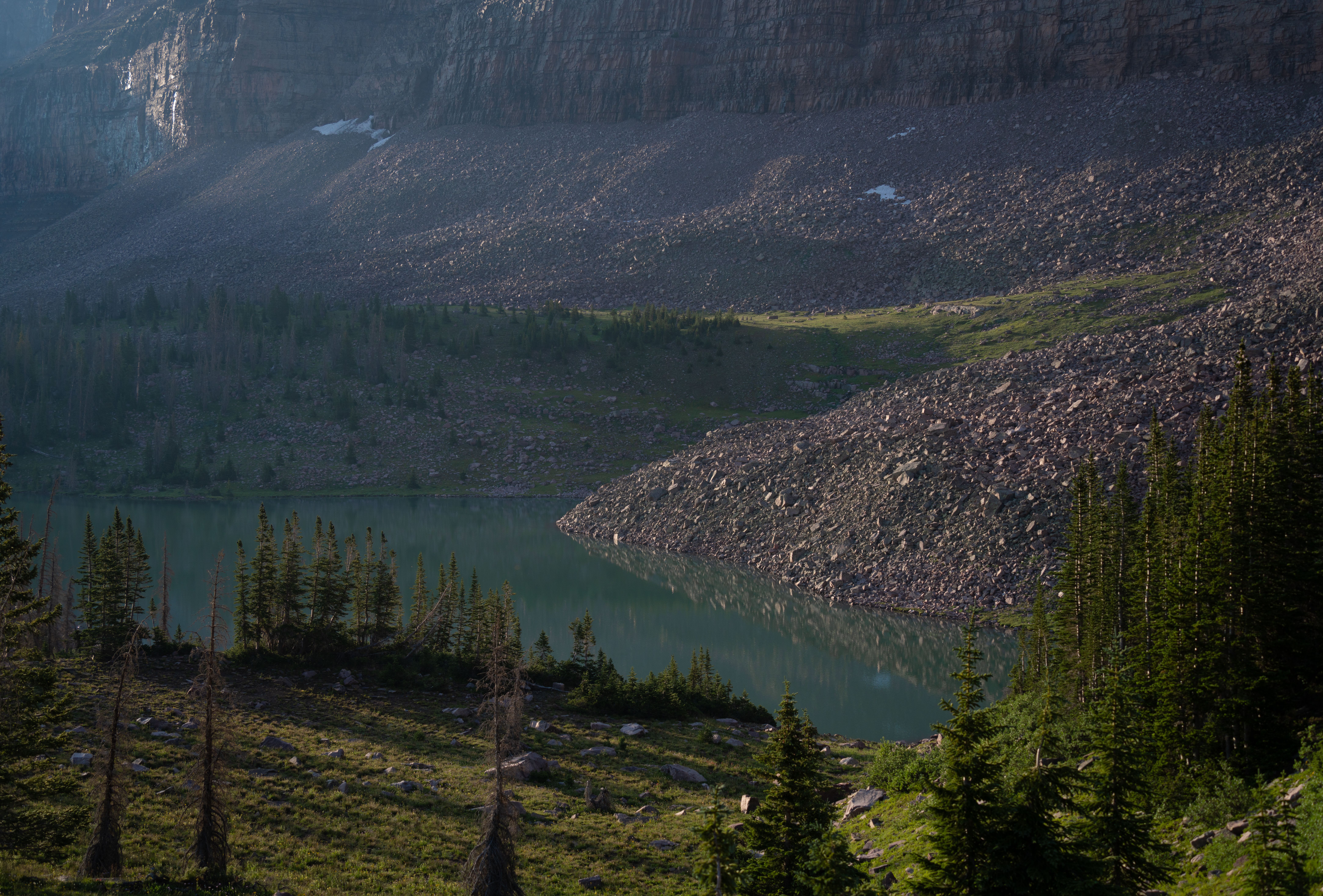 A mountain lake surrounded by trees and rocks · Free Stock Photo