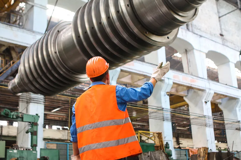 Worker directing a lift from the deck level
