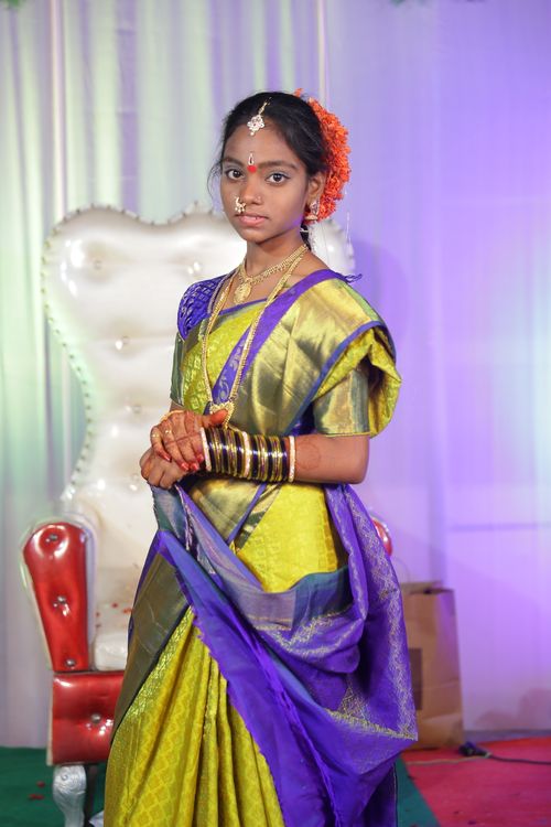 Free Portrait of a young woman in a traditional Indian saree at a cultural event. Stock Photo