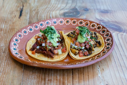 Close-up of delicious Mexican tacos with toppings on a wooden table.