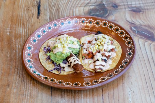 Traditional Mexican tacos with vibrant toppings served on a rustic plate, perfect for food enthusiasts.