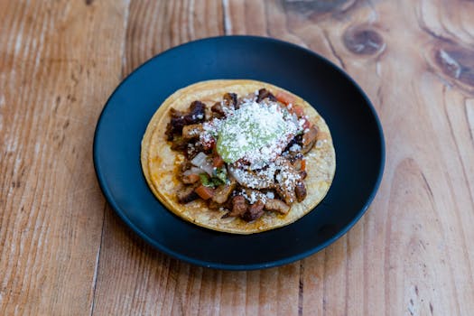 A delicious beef taco topped with fresh ingredients on a rustic wood table.